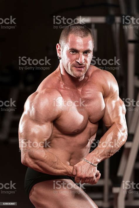 Young Bodybuilder Flexing Muscles Stock Photo Download Image Now