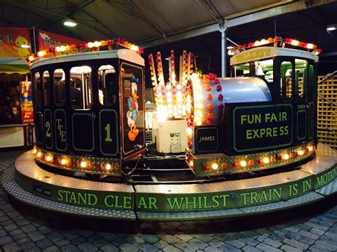 The Train Is Decorated With Festive Lights And Garlands On Its Sides