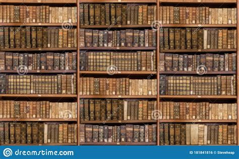 Defocused Shelves Of Old Antique Books For Background Stock Photo