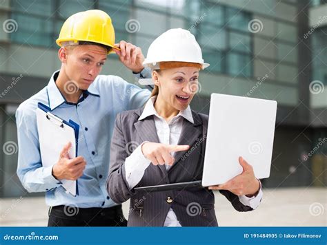 Smiling Engineer With Woman Designer Are Exploring Project In Laptop