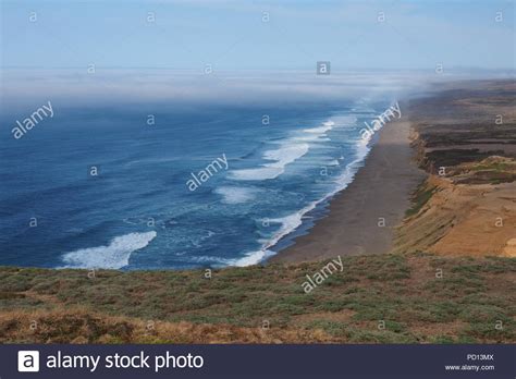 Looking Down At The Waves Breaking Onto The Beach At Point Reyes