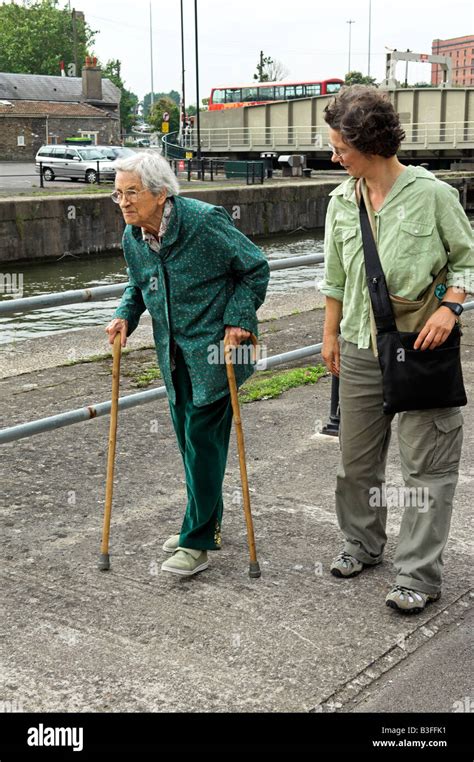 Determined Elderly English 92 Year Old Woman Walking With Two Canes