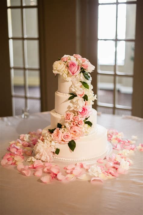 white buttercream cake with cascading blush and ivory flowers white fondant cake white