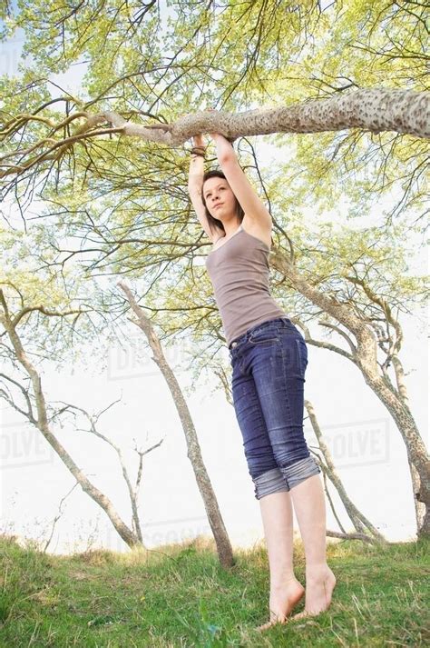 Girl Climbing Tree Outdoors Stock Photo Dissolve