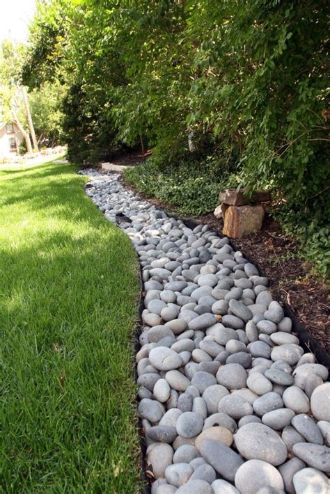dry river bed is cheap and easy to make and it looks stunning river rock landscaping