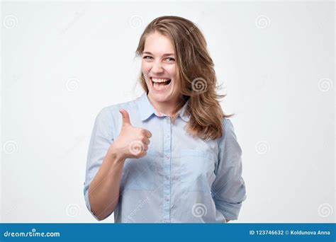 Happy Young Woman Giving Thumbs Up On White Background Stock Photo