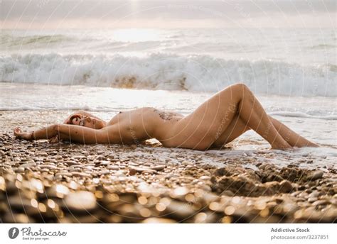Naked Woman Lying Down Near Sea Waves A Royalty Free Stock Photo From Photocase
