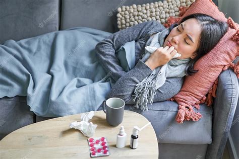 Premium Photo Sick Sad Korean Woman Lying On Sofa Feeling Unwell Catching Cold Flu And