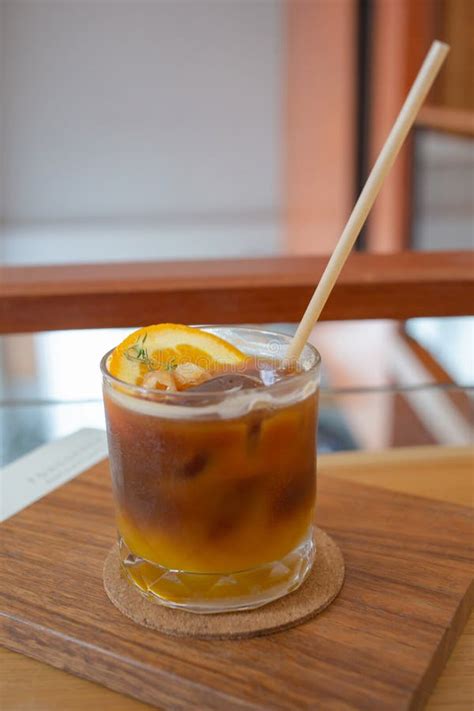 Refreshing Iced Coffee Americano Orange Juice On The Table Stock Photo