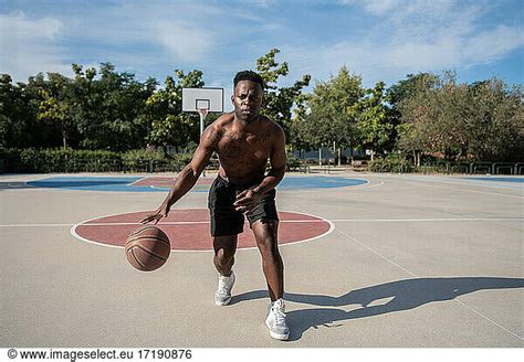 Shirtless Black Basketball Player Dribbling Ball Shirtless Black Basketball Player Dribbling