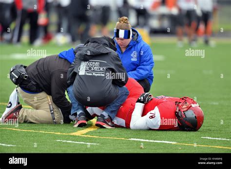 Injured Football Player Being Treated On The Field By Training And Medical Staff Usa Stock