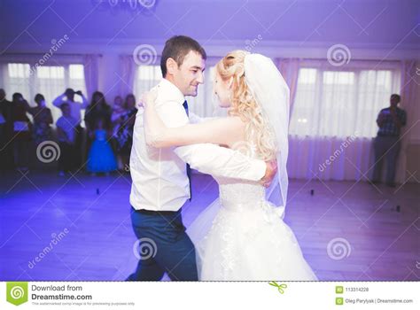 First Wedding Dance Of Newlywed Couple In Restaurant Stock Photo