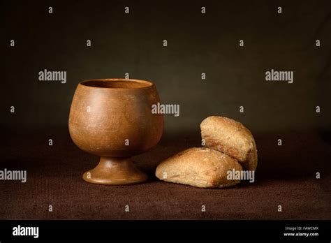 Communion Elements With Wine Cup And Bread On Table Stock Photo