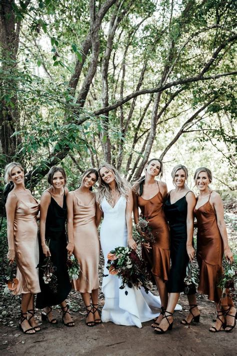 A Group Of Women Standing Next To Each Other In Front Of Some Trees And