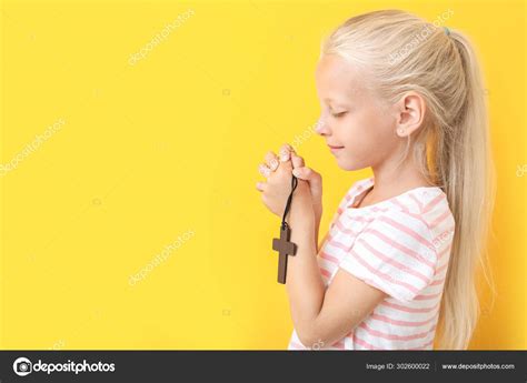 Little Girl Praying On Color Background Stock Photo By ©serezniy 302600022