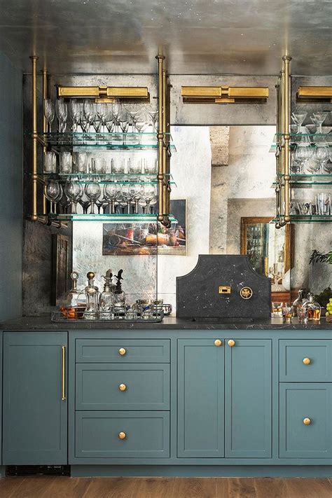 A Kitchen With Blue Cabinets And Gold Trim Around The Counter Top