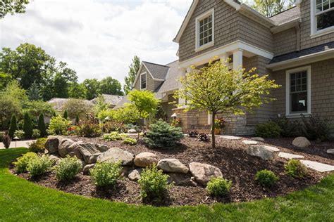 Front Yard With Boulder Wall And Shrub Bed Traditional Landscape