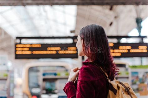Back View Of Backpacker Woman In Train Station Waiting To Travel Travel And Lifestyle Concept