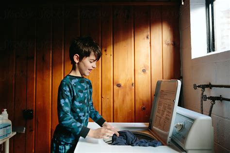 Boy Does Laundry By Stocksy Contributor Maria Manco Stocksy
