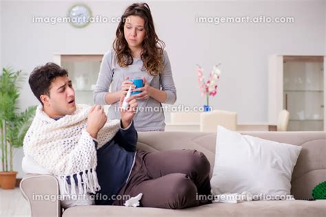 Wife Caring For Sick Husband At Home