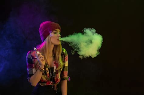 Premium Photo Vaping Girl Young Hipster Woman Vape E Cig On Black Background Hip Hop Style