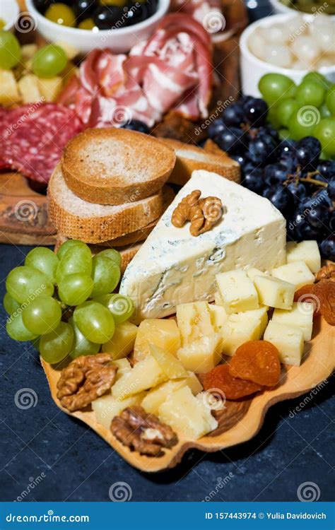 Cheese Platter On A Wooden Board Bread And Fruit Vertical Top View