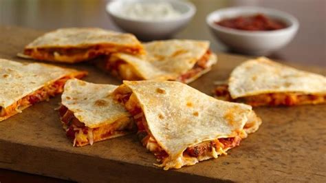 Sizzle 1/2 tablespoon of the butter in a separate skillet or griddle over medium heat and lay a flour tortilla in the skillet. Quick Chicken Quesadillas recipe from Betty Crocker