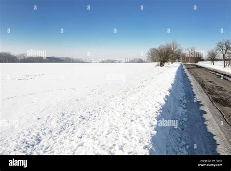 Rural Winter Scene With Snowy Field And Road Stock Photo Alamy