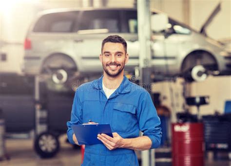 Happy Mechanic Man With Clipboard At Car Workshop Stock Photo Image
