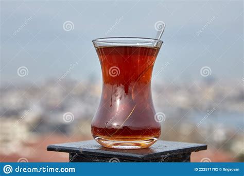 Armudu With Turkish Tea Stands Atop Rooftop Fence With Defocused View