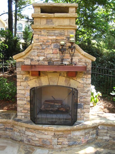 Outdoor Fireplace With Wood Mantel And Seating Wall Outdoor Fireplace