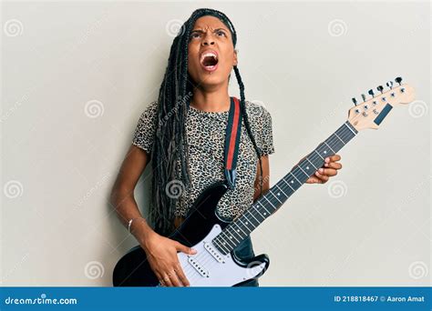 African American Woman Playing Electric Guitar Angry And Mad Screaming