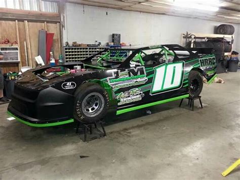 A Green And Black Race Car In A Garage