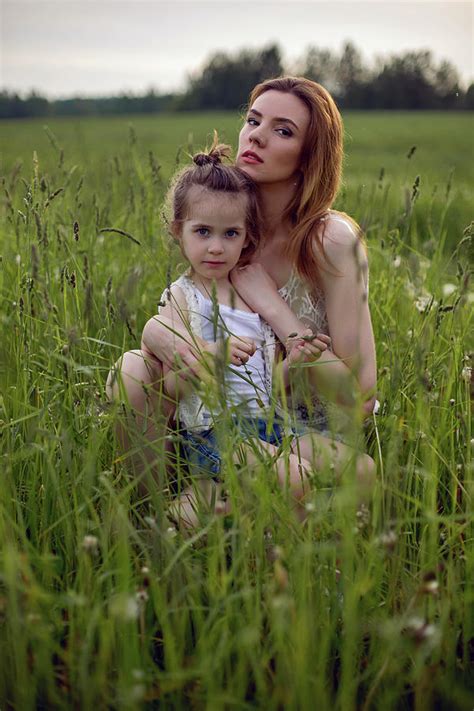 Mom And Daughter Are Sitting In A Green Field Photograph By Elena Saulich Fine Art America