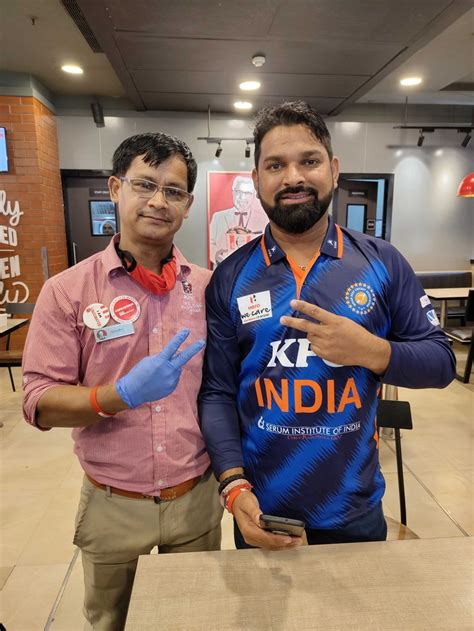 Indian deaf cricket team captain Virendra Singh (right) poses for a