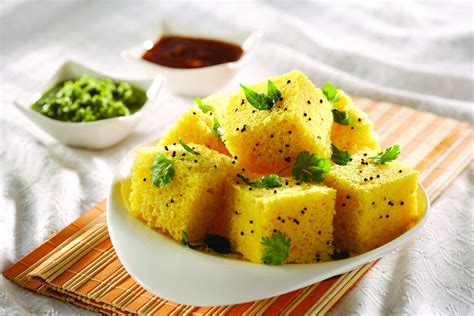 • cut dhaman dhokla into squares or diamonds and serve hot with coconut chutney. Khaman Dhokla Recipe | Khaman Dhokla Gujrati Farshan ...