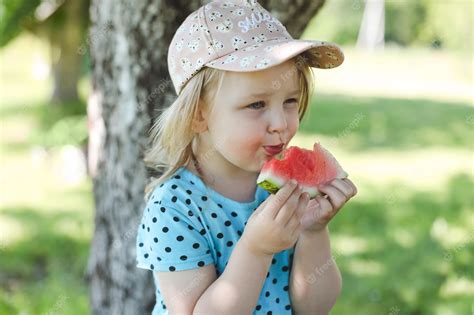 Premium Photo Cute Little Girl Eating Watermelon Outdoors In