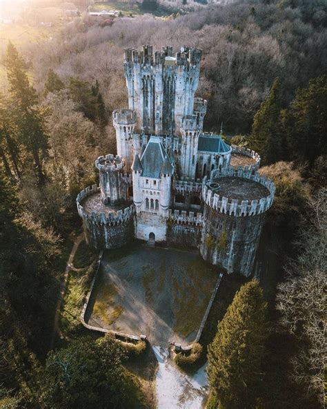 An Aerial View Of A Castle Surrounded By Trees