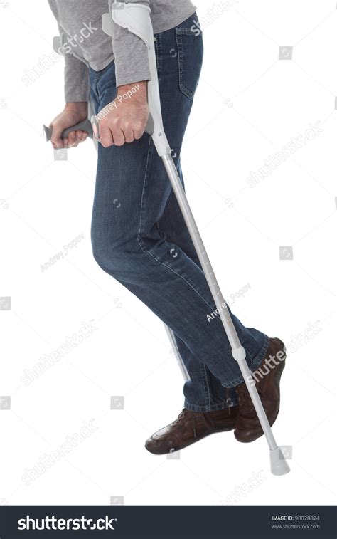 Photo De Stock Senior Man Walking Using Crutches Isolated 98028824