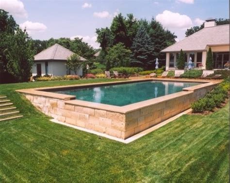 To avoid incoming water, the ground should always slope away from your home in all directions. inground pools for sloped yard