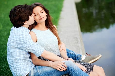 Premium Photo Man Kissing His Womanfriend On The Lake In The Summer In The Meadow