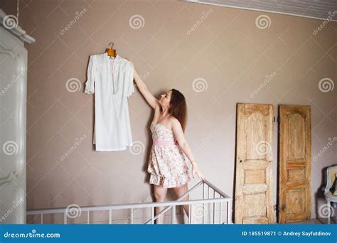 Girl Takes Off White Dress From The Wall In Bedroom Stock Image Image Of Healthy Light 185519871