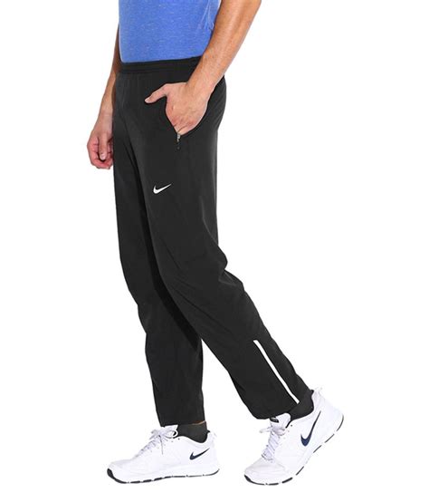 Zippered hems allow for easy on and off over shoes. Nike Black AS Dry-FiT Stretch Woven Running Track Pant for ...