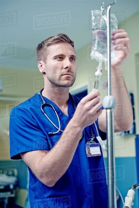 Doctor Adjusting Intravenous Drip In Hospital Stock Photo Dissolve
