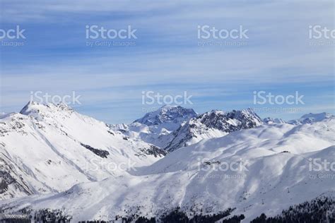 Snowy Slope In High Winter Mountains And Blue Sunlit Cloudy Sky Stock