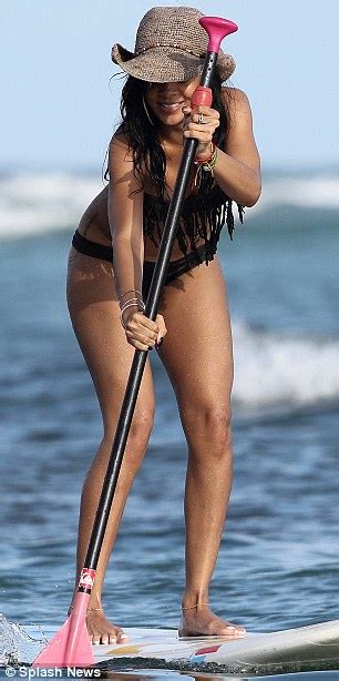 rihanna shows off her killer curves in a fringed bikini as she takes to a paddle board in hawaii