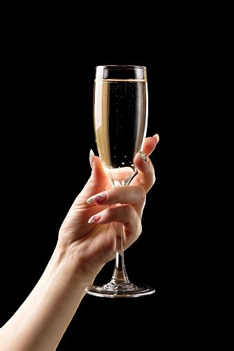 Female Hand With Champagne Glass On Black Background Stock Photo