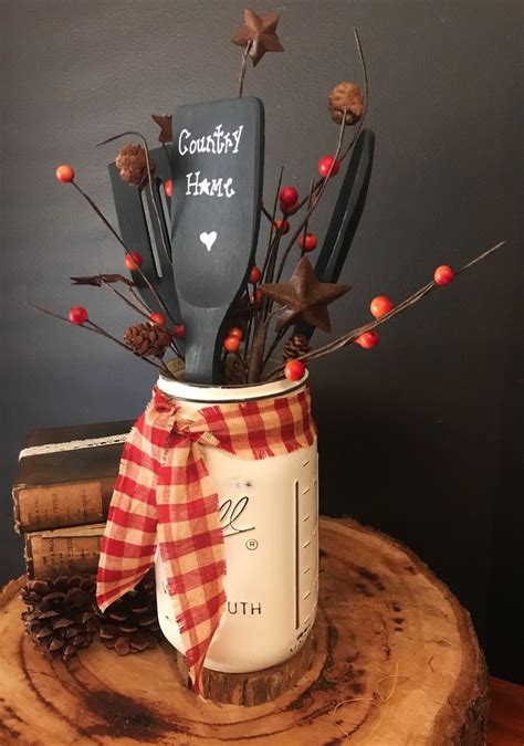 A Jar Filled With Utensils Sitting On Top Of A Tree Stump