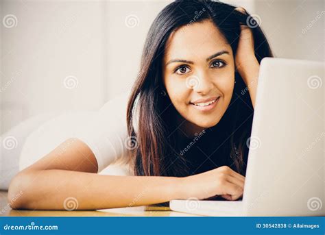 Beautiful Indian Woman Student Using Laptop Computer At Home Stock