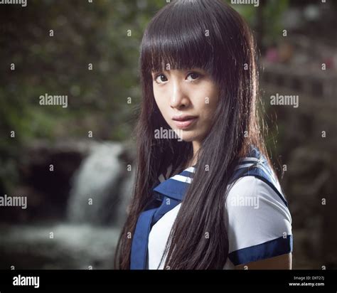 Cute Chinese Schoolgirl With Waterfall In Background Stock Photo Alamy